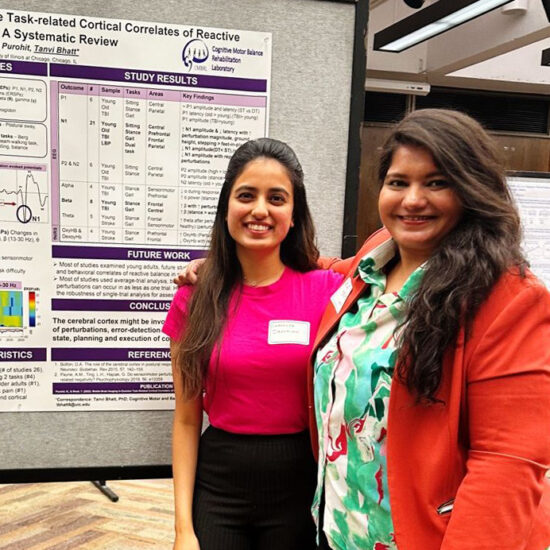 Two women in front of a research poster