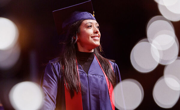 UIC student in graduation cap and gown