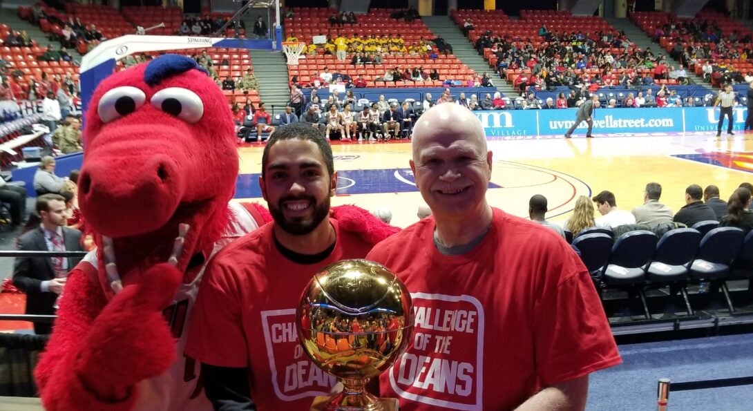 Dean Bo Fernhall, PT student Josuf Robinson and Sparky D. Dragon pose with the Challenge of the Deans championship trophy