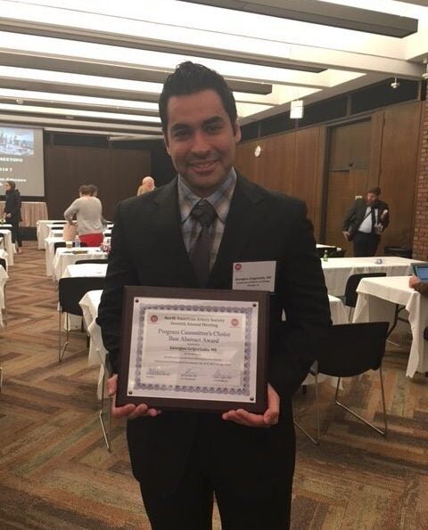 Georgios Grigoriadis holding his NAA award certificate