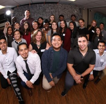 AHS students and Eileen Doran, Assistant Dean of the UIC College of Applied Health Sciences, gather for a group photo during the power hour event
                  