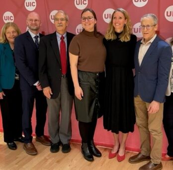 A group of eight AHS faculty members pose for a photo
                  